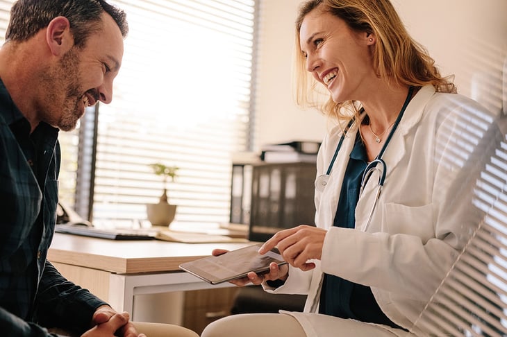 Female-doctor-showing-good-test-results-to-a-male-patient-1135492654_7388x4926-1