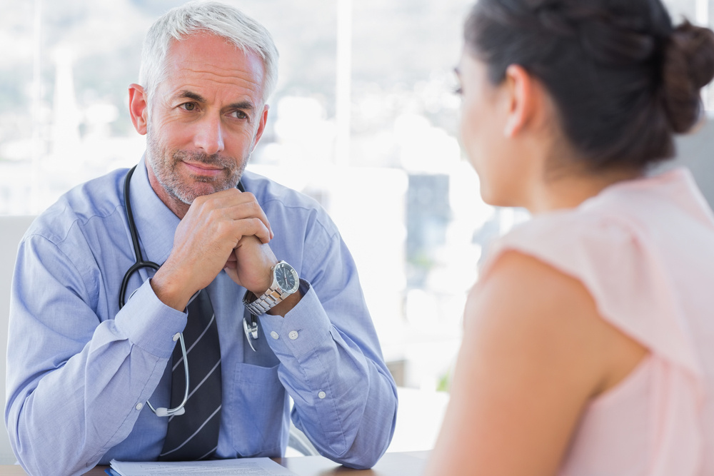 Serious doctor listening to patient explaining her painful in his office-Jul-18-2024-01-53-00-8011-PM