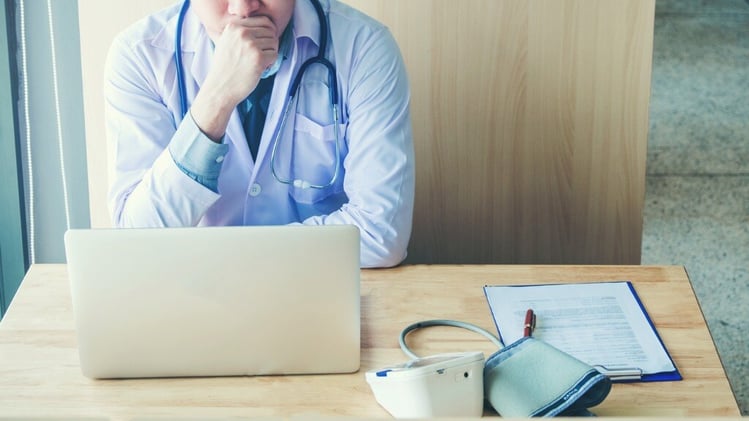 doctor-is-working-in-office-sitting-thinking-about-disease-problem-of-picture-id994672252